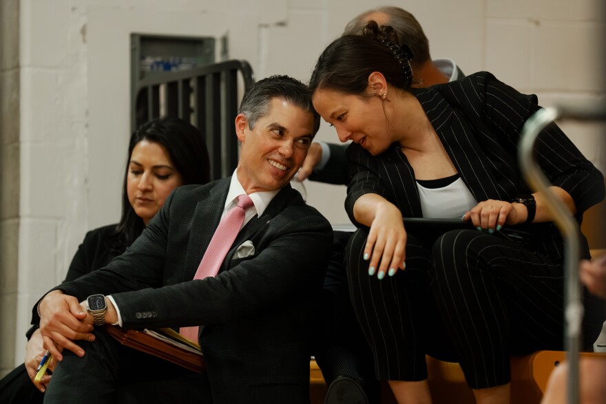 Representatives with CRG — a Clayco company specializing in real estate and data center development — speak to each other as hundreds of Festus residents testify to oppose a plan to develop a large-scale data center in the community on Monday night.