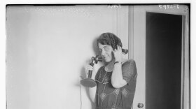 vintage photo from 1900 of a woman answering a phone