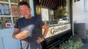 Garnett's manager John Murden holds a cupcake, given to customers on their 17th birthday, celebrated earlier this month. 