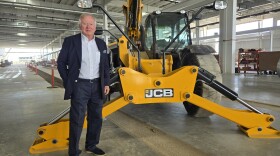 Lord Anthony Bamford, chair of JCB, poses next to equipment made by the company during a tour of its future San Antonio plant on March 30, 2026
