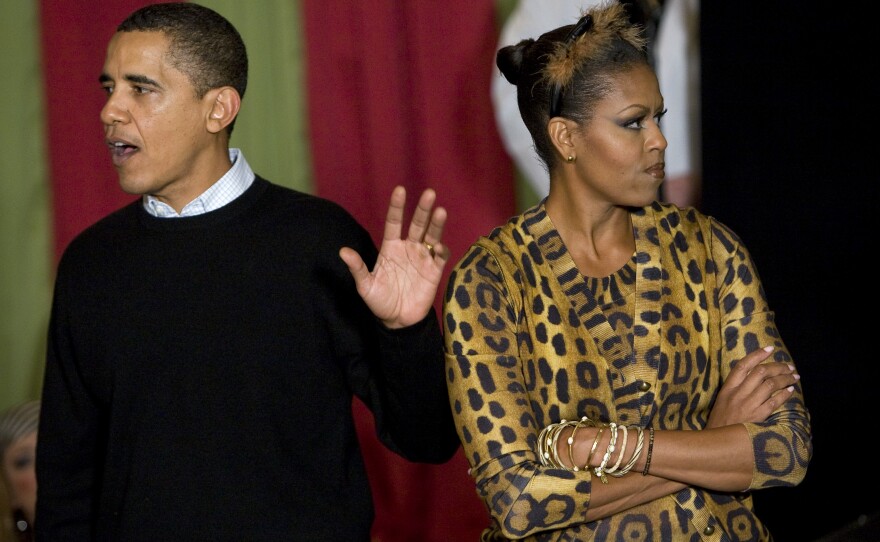 President Obama is trying to justify his lack of costume and Michelle is NOT. HAVING. IT. This is what happens when you don't dress up. (The Obamas greet trick-or-treaters at the White House in 2009.)
