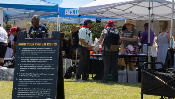 Representatives with the American Civil Liberties Union of South Carolina meet with people outside the Statehouse in Columbia.