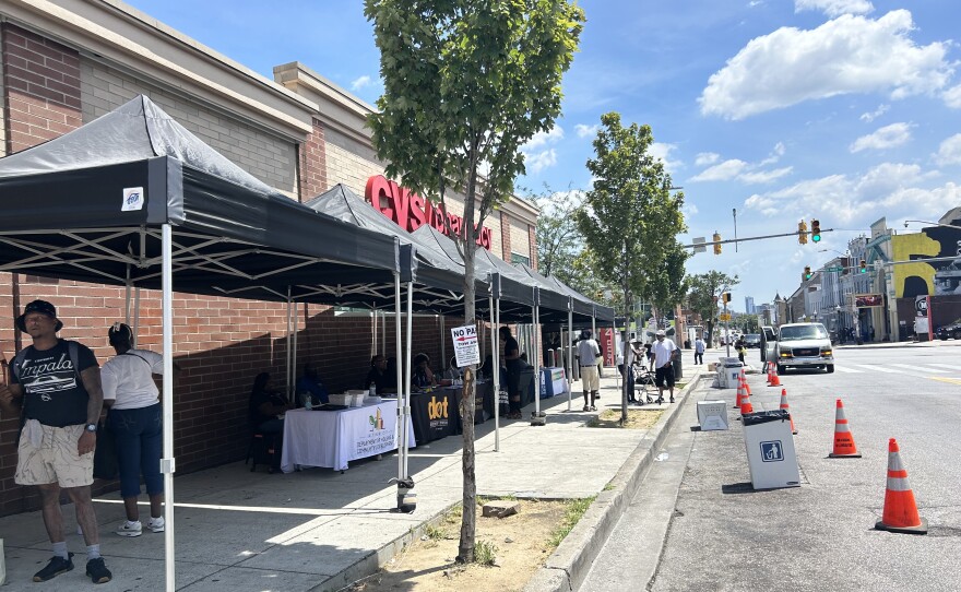Booths offered naloxone, rehabilitation services and even free pizza near the Penn North Metro Subwaylink station. Photo by Scott Maucione/WYPR.