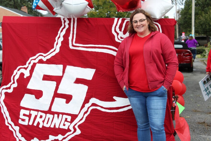 Jessica Salfia poses next to a parade float before the Mountain State Apple Harvest Festival in Martinsburg, West Virginia. 