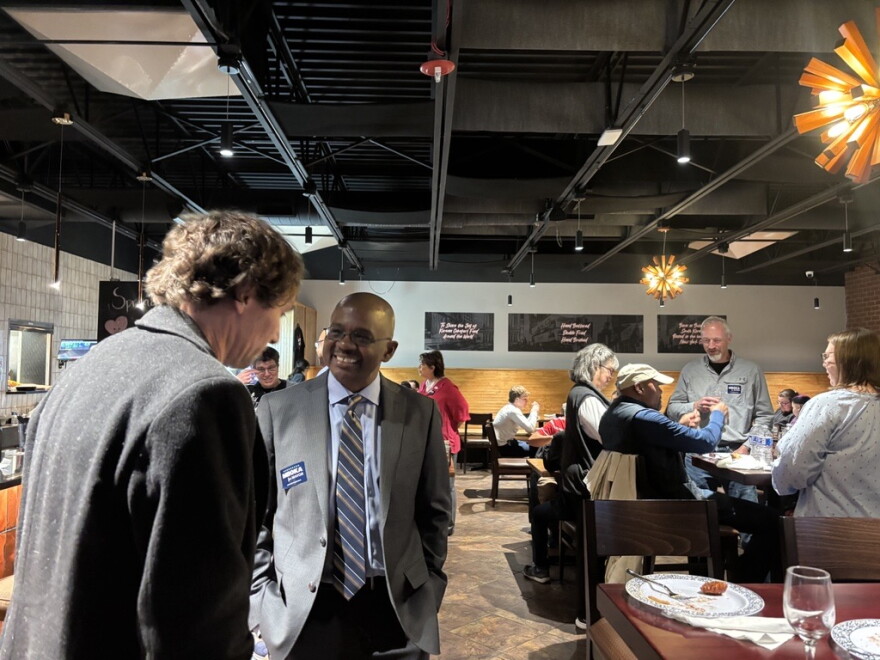 Bloomington Mayor Mboka Mwilambwe talks to a guest at Tuesday's watch party at Bonchon.