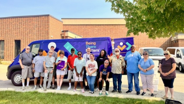 Members of LifeCare Alliance stand in front of a Meals on Wheels delivery van in Dayton