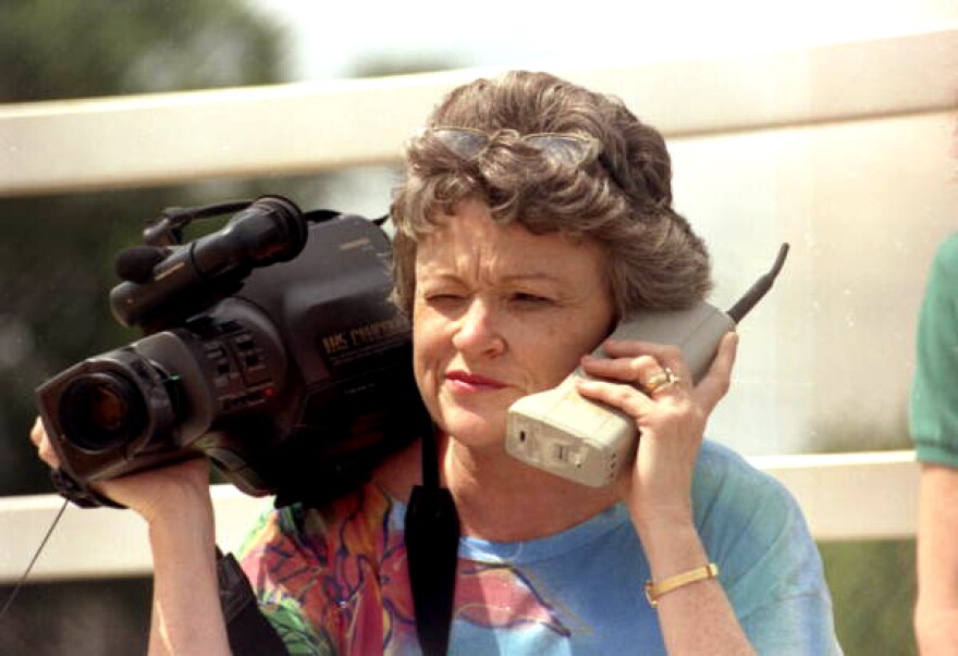 Lucy Morgan with video camera and phone.