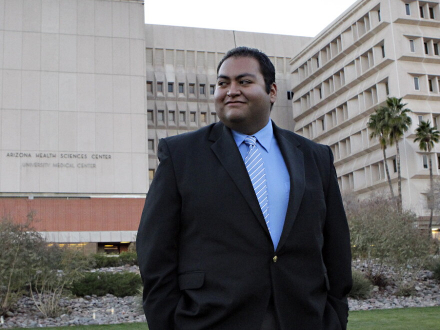 Daniel Hernandez walks across the lawn outside University Hospital in Tucson on Sunday. Prior to his current internship he worked on Rep. Gabrielle Giffords' 2008 campaign.