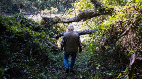 Jerry Gutierrez walks down a trail to the Kiamichi River.