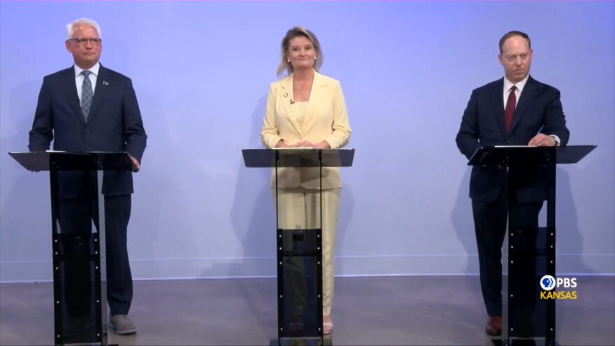 From left, Democrats Curt Skoog, Cindy Holscher and Ethan Corson share their views on a looming budget problem and the deal to bring the Chiefs across state lines during a gubernatorial debate broadcast July 16, 2026, by PBS Kansas.