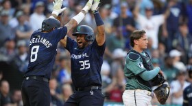 National League's Elias Díaz, of the Colorado Rockies (35), celebrates his two run home run with Nick Castellanos (8), of the Philadelphia Phillies, in the eighth inning during the MLB All-Star baseball game in Seattle, Tuesday, July 11, 2023. (AP Photo/Lindsey Wasson)