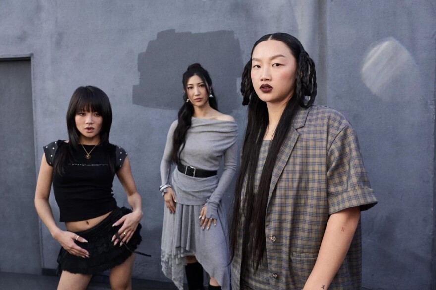 Artists Rei Ami (left), EJAE and Audrey Nuna are behind the singing voices of the fictional girl group HUNTR/X in KPop Demon Hunters.