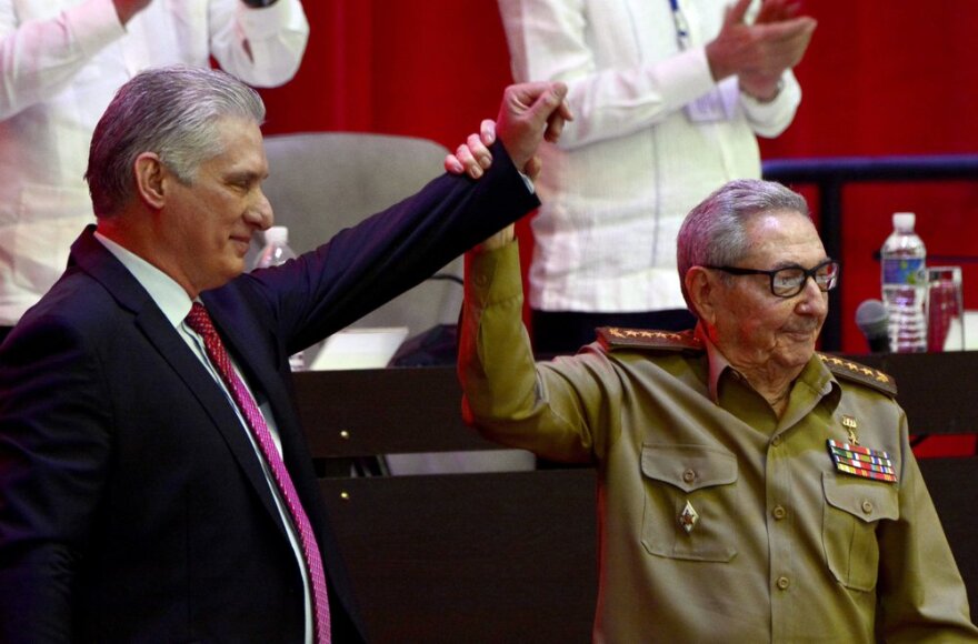  Outgoing Cuban Communist Party First Secretary Raul Castro (right) presents his replacement, Cuban President Miguel Diaz-Canel at the close of the party's 8th Congress in Havana on Monday.