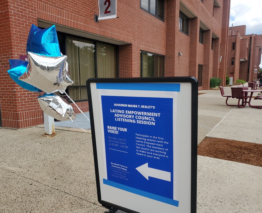  The first in a series of listening sessions in Latino communities across the state was held at Springfield Technical Community College on June 10, 2023. A sign with an arrow leads people to the event. 