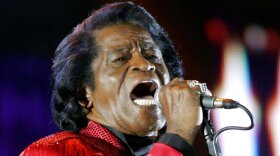FILE - In this July 6, 2005 file photo, James Brown performs on stage during the Live 8 concert at Murrayfield Stadium in Edinburgh, Scotland. The family of entertainer James Brown has reached a settlement ending a 15-year battle over late singer’s estate. David Black, an attorney representing Brown’s estate, confirmed to The Associated Press on Friday, July 23, 2021 that the agreement was reached July 9. (AP Photo/Matt Dunham, File)