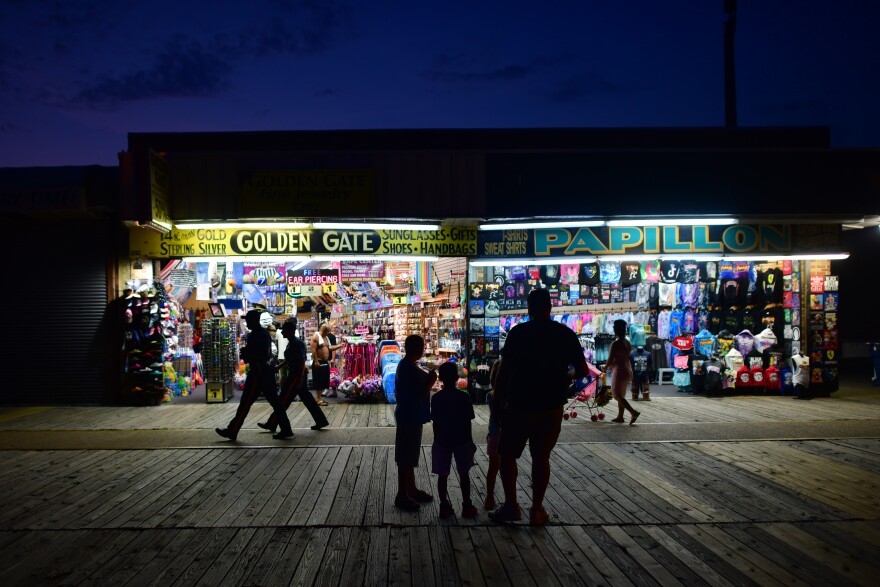 People walk the boardwalk in early July in Wildwood, N.J., after some coronavirus restrictions were lifted. There's concern that case counts could push back up in Mid-Atlantic and Northeastern states.