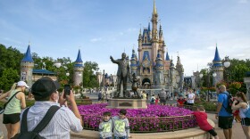 People visit the Magic Kingdom Park at Walt Disney World Resort in Lake Buena Vista, Fla., April 18, 2022. Ongoing strength at its theme parks and an improving streaming business propelled The Walt Disney Co. to higher profits and revenue in its fiscal second quarter in 2023. 