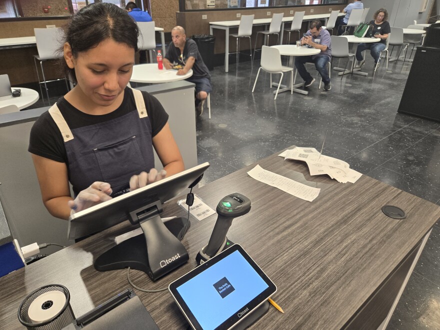 Cashier Sofia Flores takes payments from customers of The Docket Cafe on Aug. 26, 2025