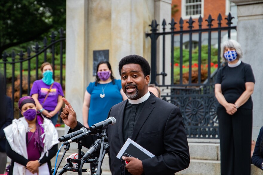 Rev. Rashaan Hall speaks outside the Massachusetts Statehouse Friday, July 17, 2020. Hall is the racial justice program director at ACLU Massachusetts, and said qualified immunity has allowed police officers to escape civil liability. 