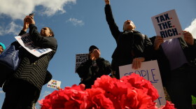 FILE: Rally-goers chant outside the Connecticut State Capitol with a basket of red poppies, which protestors were distributing “honoring working-class lives lost in imperialist wars.” Hundreds marched and rallied in downtown Hartford, May 01, 2026, the delivered a letter to Governor Ned Lamont’s office calling for a state budget that prioritizes investments in “housing, healthcare, public education, climate justice, and fair union contracts.”