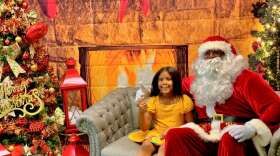 5-year-old Lexia visits Santa Timothy in Casselberry. (photo by Talia Blake/WMFE)