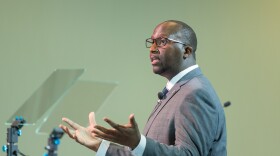 Warren Morgan speaks with his hands held open.