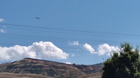 A helicopter flies over the Dikker Hill fire July 25, 2024. Smoke had died down by day no. 2 of the blaze.