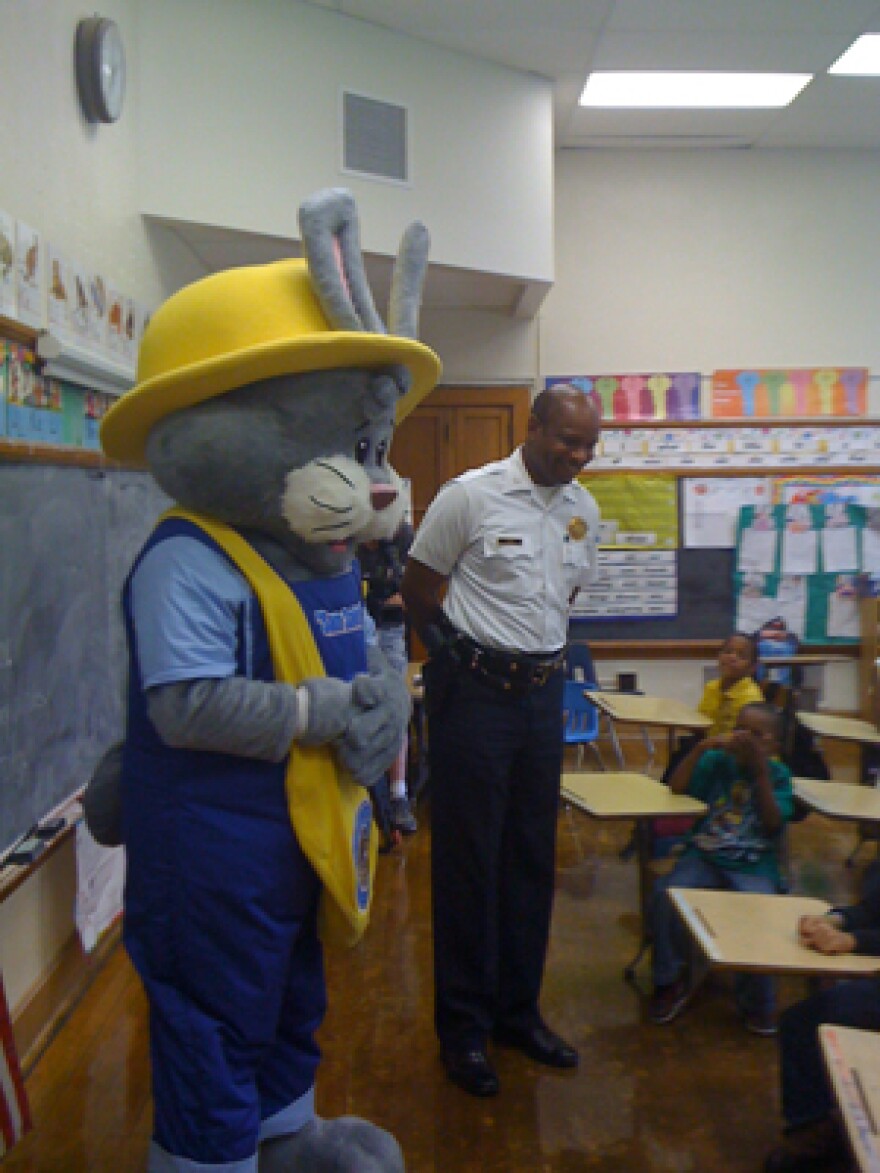 "Sam Safety," (left) along with St. Louis Police Chief Dan Isom visit students at Cote Brilliant School. "Sam" is the Department's mascot for the "Officer Friendly" community outreach program.
