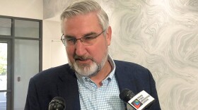 Indiana Gov. Eric Holcomb speaks with reporters during the Indiana Technology and Innovation Association conference in Fishers, Ind., on Friday, Oct. 8, 2021. Holcomb said he had not yet decided whether to appeal a court decision against his lawsuit challenging the expanded power state legislators gave themselves to intervene during public health emergencies.