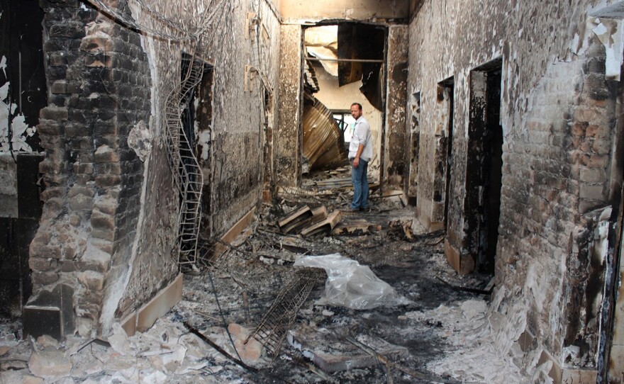 On Oct. 16, 2015, an employee of Doctors Without Borders stands inside the charred remains of the organization's Kunduz hospital following a U.S. airstrike.