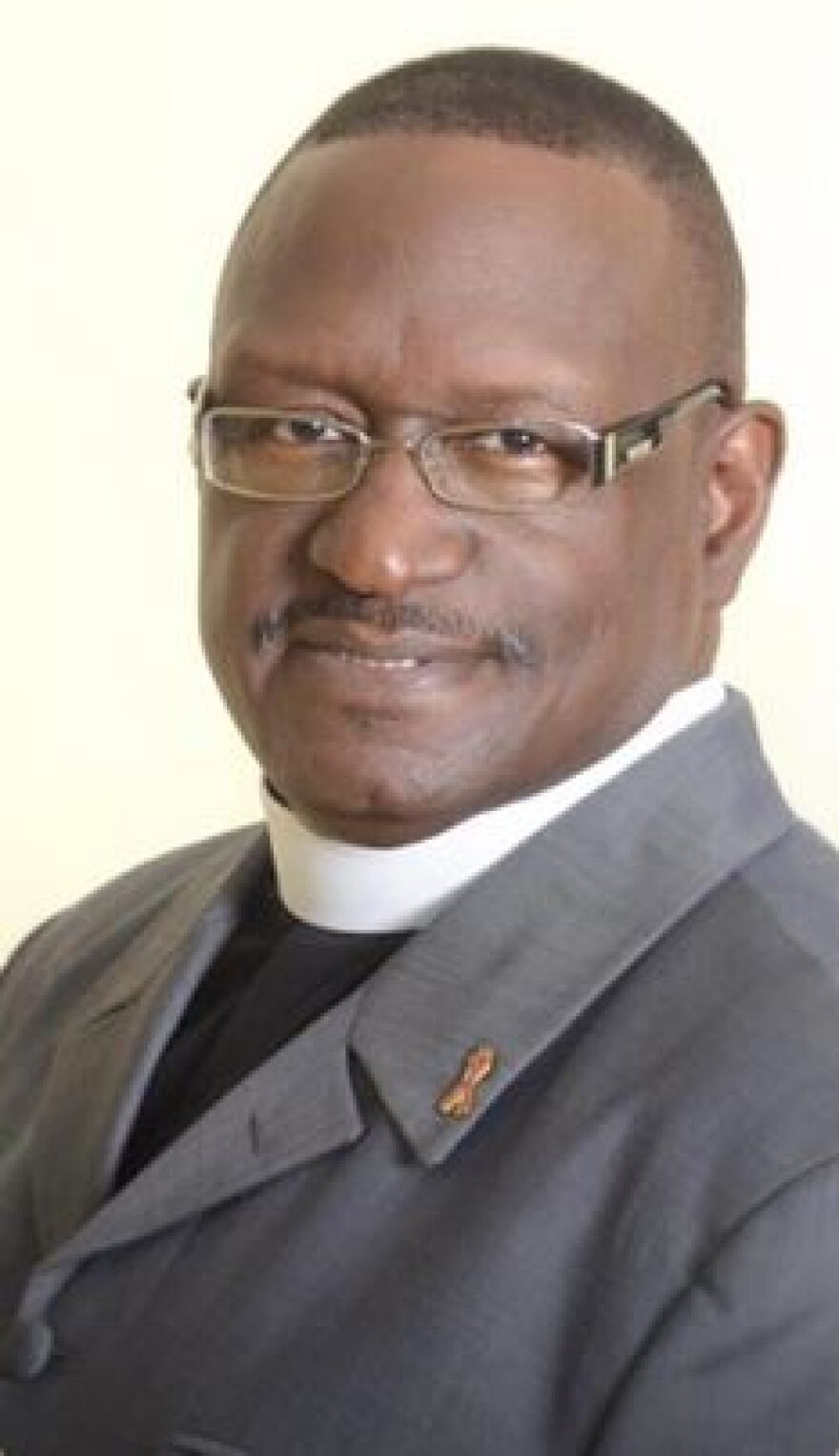 A headshot of Rev. James Lewis in his pastoral collar.