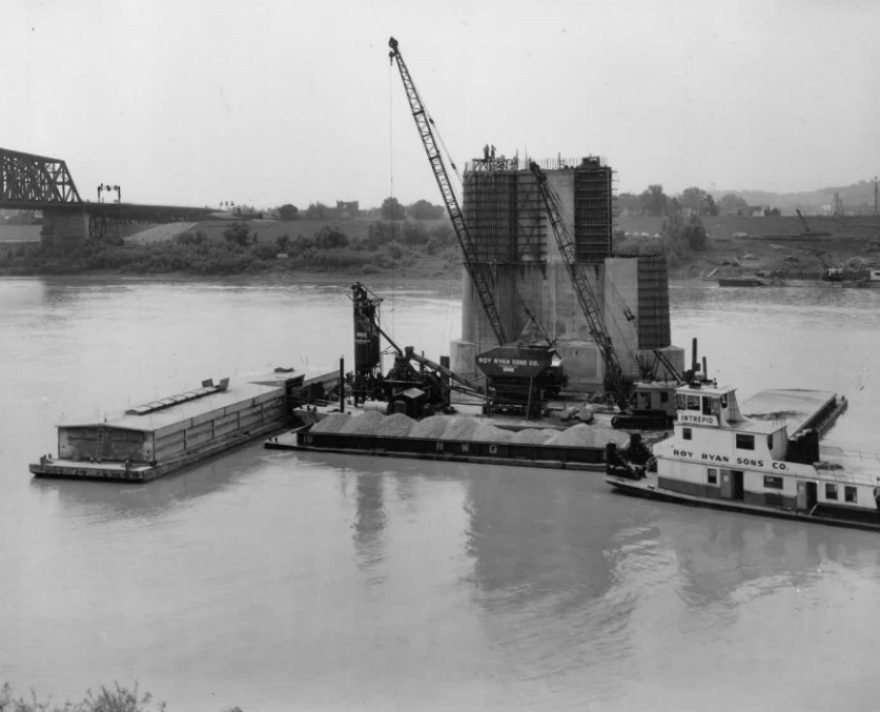 Cranes delivered by barges constructing one of the footers of the original Brent Spence Bridge