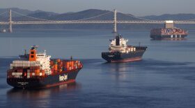 Container ships sit idle in the the San Francisco Bay just outside of the Port of Oakland in San Francisco, California.