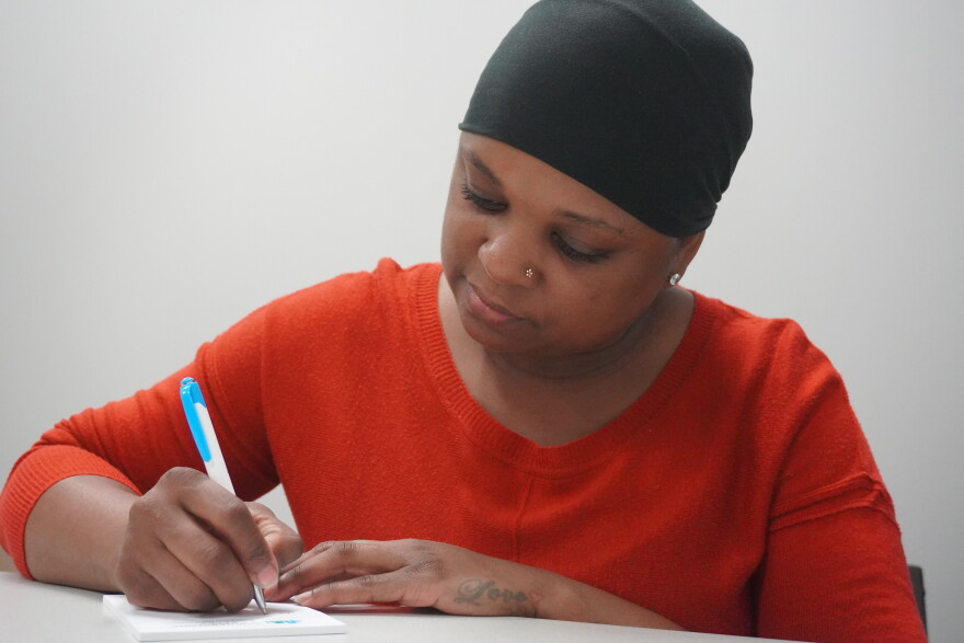 Elsie Alex-Tanner, crisis intervention specialist at Marion Senior Services, writing on her notepad. (Rachel Hunter/WUFT News)
