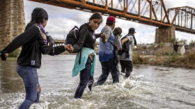 Immigrants from Venezuela cross the Rio Grande from Mexico into the United States on Sept. 30, 2023 in Eagle Pass, Texas.