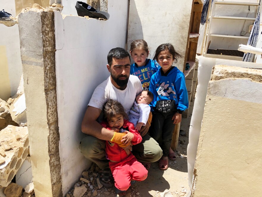 Ahmed Jumaa with his three children and niece. He and 14 family members fled to Lebanon from Syria six years ago. "I built this house with my own hands, and I'm now destroying it with my own hands," he says.