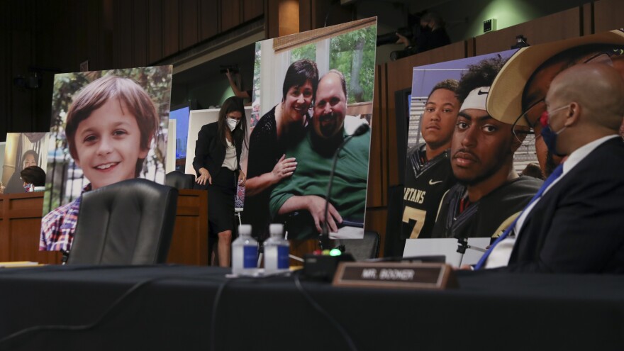 Democrats on the Senate Judiciary Committee display photos of Americans who have benefited from the Affordable Care Act during Amy Coney Barrett's Supreme Court confirmation hearing on Monday.