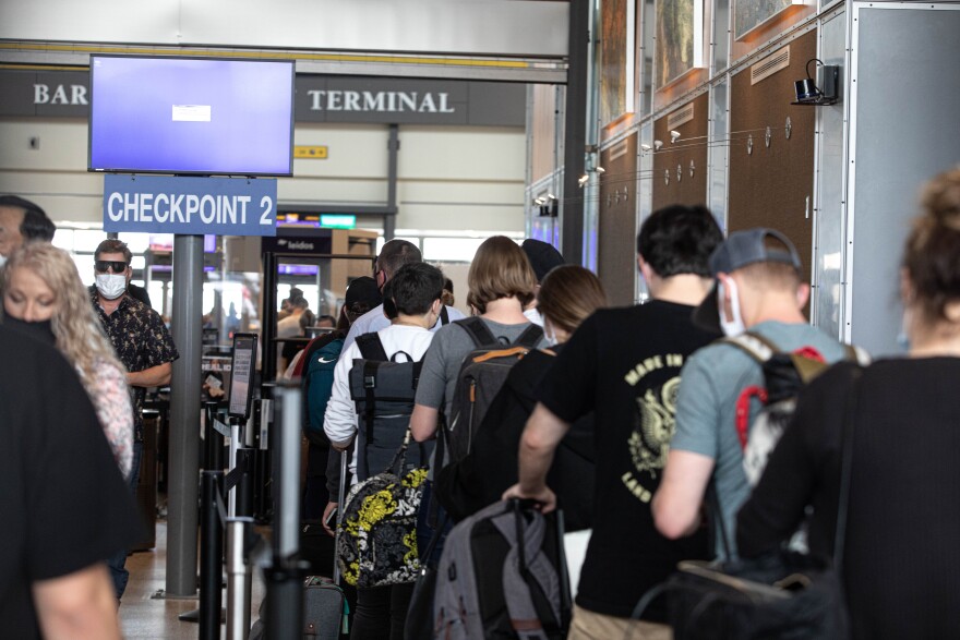 Travelers wait in line at TSA Checkpoint 2 on April 4, 2022.