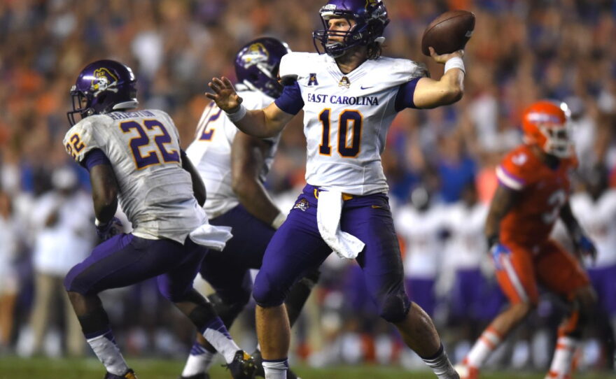 East Carolina quarterback Blake Kemp (10) rears back to throw a pass to a receiver.