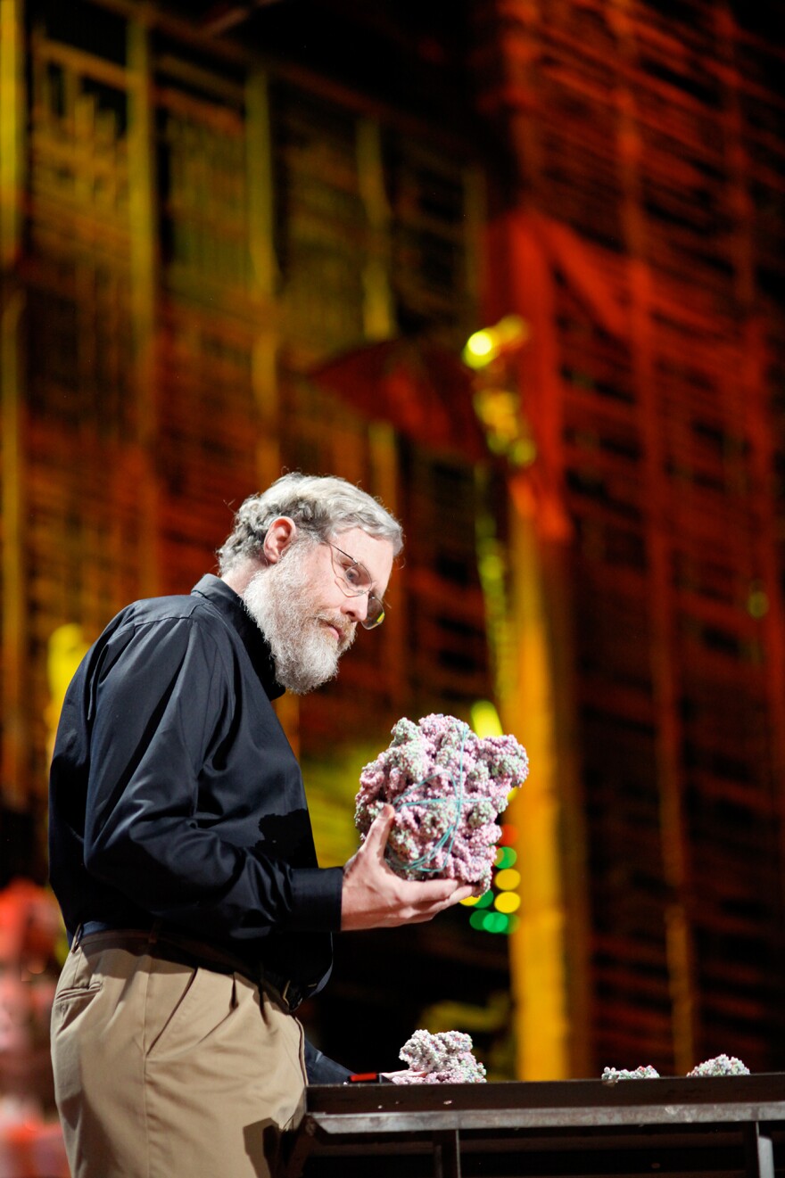 George Church, a professor of genetics at Harvard Medical School, seen looking at a molecular model, says an effort to create synthetic humane genomes could someday have medical applications.