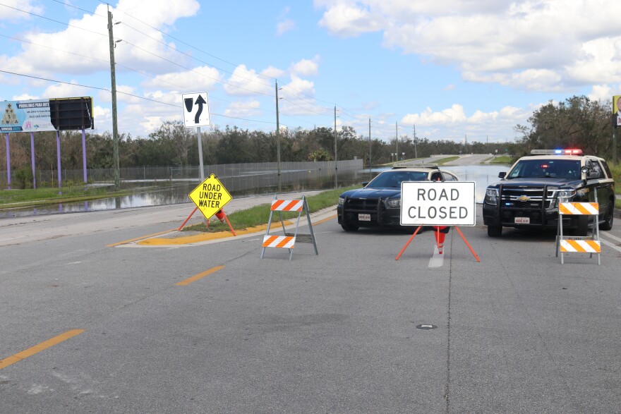 Florida Highway Patrol troopers reroute drivers to their destination at a closed flooded road in Arcadia, Florida. (Jake Reyes/WUFT News)