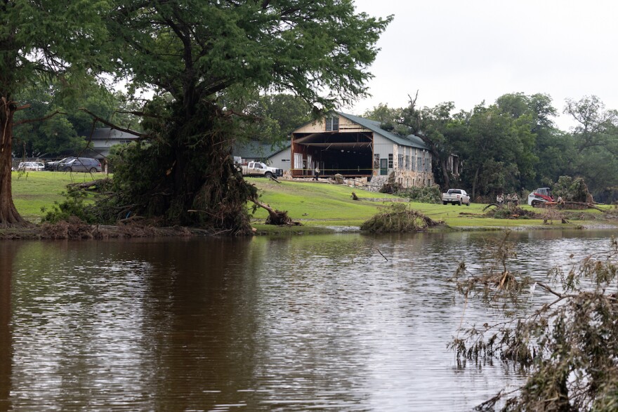 Law enforcement agents outside of a torn building at Camp Mystic on Sunday, July 6, 2025. Law Enforcement and volunteers are in search for missing people due to heavy rainfall the caused flooding along Guadalupe River. Patricia Lim/KUT NewsPatricia Lim/KUT News