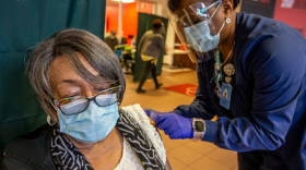 Betty Sweeney of Greensboro gets a band aid after receiving her 2nd COVID-19 vaccination from Guilford County Health and Human Services registered nurse Kimble Capel at the Mount Zion Baptist church vaccination clinic in Greensboro, on Thursday, February 11, 2021.
