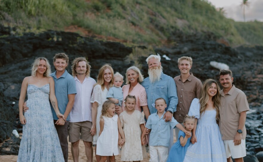 Jeff and Tami Gray with their family on the beach