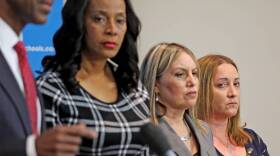 Broward County Public Schools Superintendent Robert Runcie outlines changes he has implemented in the district since last year's deadly shooting. School board members stand beside him, including Lori Alhadeff (far right), whose daughter Alyssa was killed.