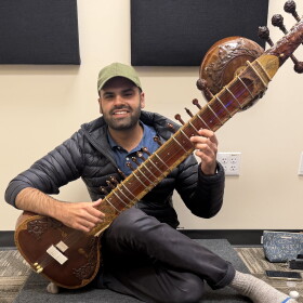 Musician Keshav Batish with his sitar in the KAZU studio
