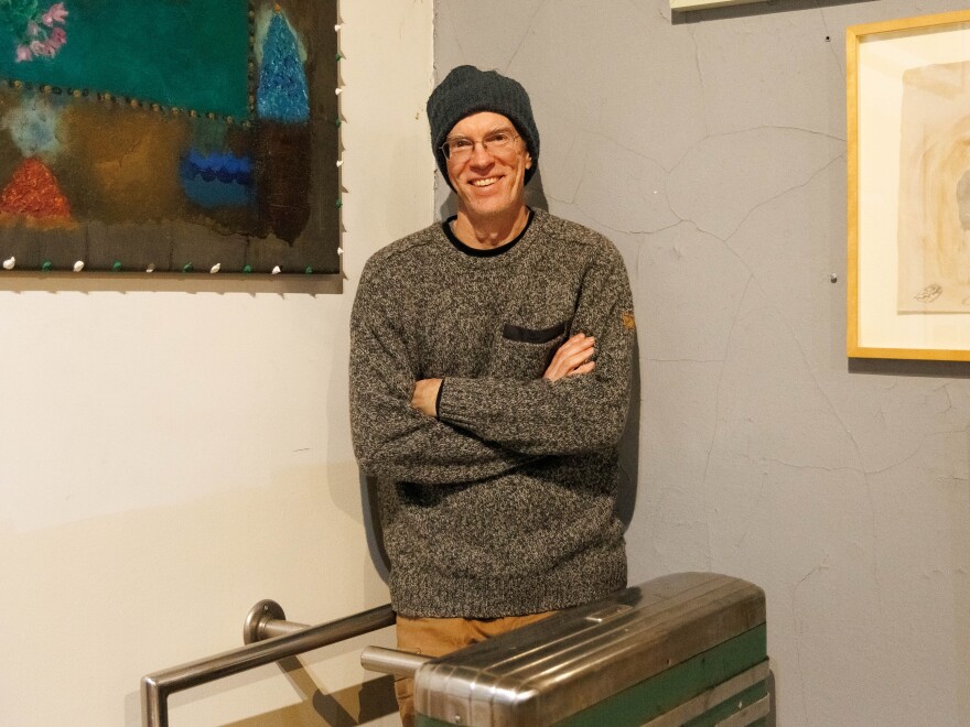 Matt Erickson standing in a turnstile at Come together Space.