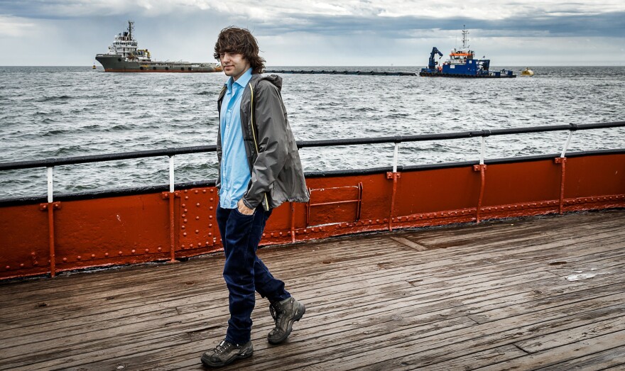 Boyan Slat walks in front of his first prototype ocean cleanup device on June 23, 2016.