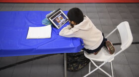 A child attends an online class at a learning hub inside the Crenshaw Family YMCA during the pandemic in February in Los Angeles, California. The learning hub program provides structured distance education resources including free WiFi, electricity, staff support, academic tutoring, and recreation activities to provide a safe environment to support low income and minority communities. (PATRICK T. FALLON/AFP via Getty Images)