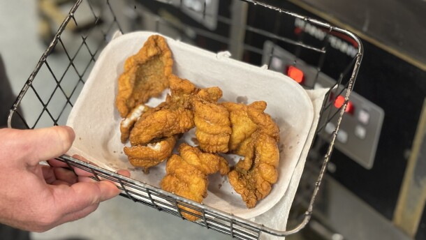 Kyle Rowley holds a basket full of freshly fried blue catfish at Skrimp Shack in Hampton on April 15, 2026.